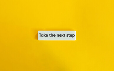 Take the next step Phrase. Text on Block Letter Tile on Yellow Background. Minimal Aesthetic.