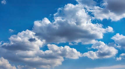 Beautiful clear blue sky with white clouds in background, suitable for nature landscape in summer, spring or autumn on sunny day. Ample 2/3 space for text.