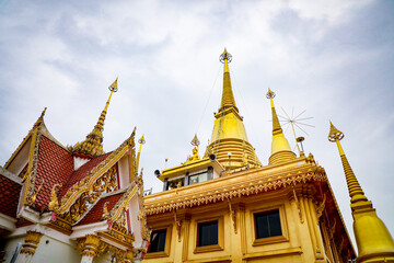 Fototapeta premium Wat Khiriwong, the highlight is the Ubosot and Phra Chulamani Chedi, located on the top of Khao Daowadueng, and offers a high angle view of Nakhon Sawan. It is a beautiful sunset viewing point.