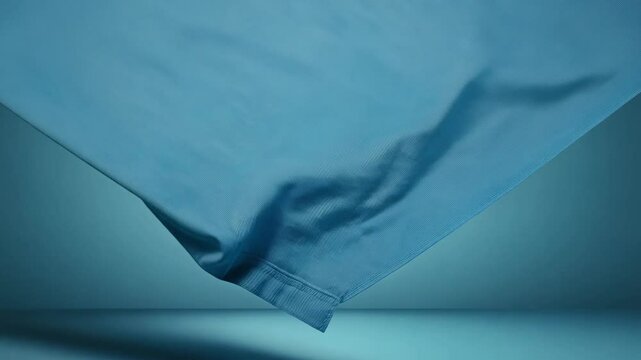 Dolly in and pan, ambient light, 3d render abstract steel blue background with folded denim floating steadily, the scene evokes casualness with denim drapery draping