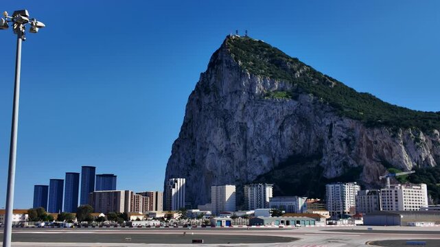 Winston Churchill Avenue crossing the Gibraltar International Airport runway with the north face of the rock in the background