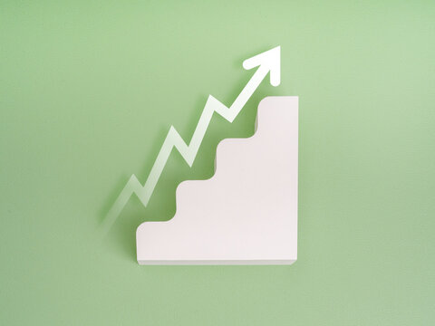 Rise up glowing arrow, volatility index chart on white blocks business chart steps on green background. Business growth graph process, goal, success and economic improvement and analysis concepts.