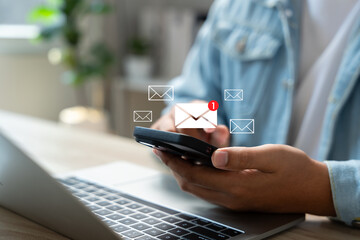 New email notification alerts concept for Digital marketing business communication through virtual inbox and internet technology as Business people use smartphone with email on a virtual screen