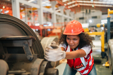 An industrial worker operates machinery in a modern factory environment focusing on production processes quality control mechanical operation workplace safety and efficient material handling