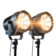 Two studio lights stand side by side illuminating a dark background with bright warm light sources