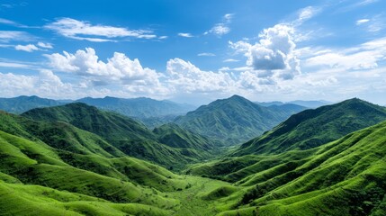 Fototapeta premium Lush Green Mountain Range Under a Clear Blue Sky - Serene landscape, rolling hills, vibrant greenery, vast expanse, peaceful nature. Symbolizing tranquility, abundance, growth, freedom, and renewal