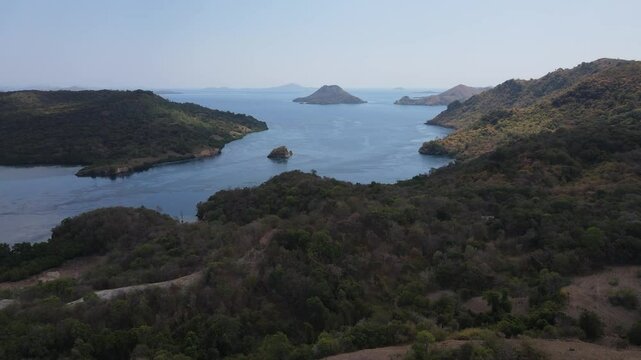 Aerial drone landscape view of Golo Mori island mountain peak in Labuan Bajo, Indonesia.