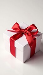 Fototapeta premium Elegant red ribbon tied gift box, white background, xmas, sale