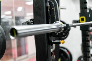 sstkWellness captures the essence of modern fitness with this striking image of a mechanical strength training machine loaded with weight plates, highlighting the synergy between structured physical