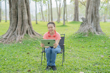 Woman uses iPad to listen to music outdoors