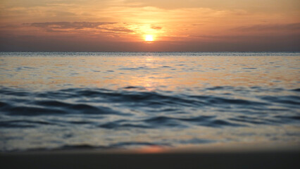 Landscape image of a beautiful sunset sky and sea wave on beach