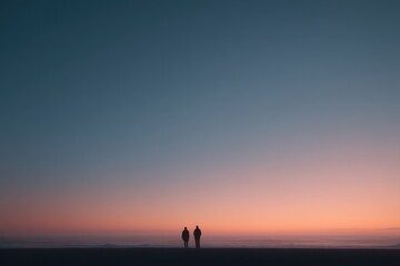 Fototapeta premium two silhouetted figures walking hand-in-hand at twilight on deserted beach with ample copy space overhead