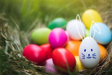 multicolor Easter eggs, blurred meadow flowers in an affectionate moment, blurred green grass 