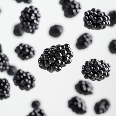 Blackberries rolling across a clean white surface