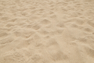clean fine beach sand surface on bright sunny day, light beige or golden color soft and powdery particles, natural background of calming and natural beauty in soft focus