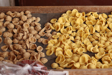 Orecchiette, a type of Italian pasta. Demonstration of the famous Apulian orecchiette common in Italy. Varieties of fresh pasta with different flavors. Italian pasta in the shape of small ears