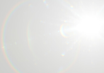 Intense light source creates a large arcing lens flare with vibrant rainbow spectrum on transparent background