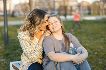 A tender moment where a mother styles her daughter’s hair, radiating warmth and love during a...