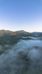 Aerial View of Lush Green Mountains with Fog