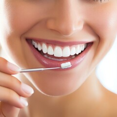 dentist applying fluoride treatment to a smiling patient clean white backdrop