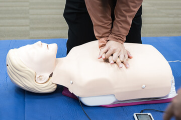 Demonstrating CPR (Cardiopulmonary resuscitation) training medical procedure on CPR doll in the class.Doctor and nurse students are learning how to rescue the patient.First aid for safe life concept