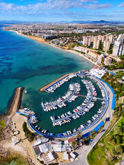 Aerial view of Dehesa de Campoamor resort town, with marina, residential houses and bay of Mediterranean Sea. Province of Alicante, Spain. Costa Blanca