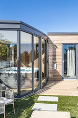 modern glass-enclosed outdoor hot tub
