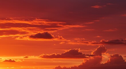 Dramatic sunset over clouds, burning sky with fiery red and orange colors