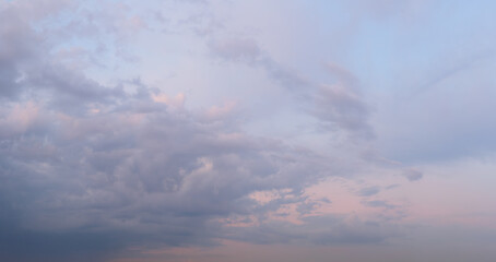 Beautiful evening heaven red sky sunset with different clouds with gaps in clear blue sky