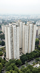 Obraz premium four light beige apartment buildings viewed from above in a hazy cityscape