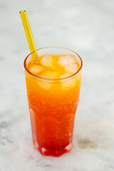 Dirty Soda with Ice Cubes in Tall Glass on Gray Background, Trendy Carbonated Drink Concept