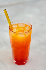 Dirty Soda with Ice Cubes in Tall Glass on Gray Background, Trendy Carbonated Drink Concept