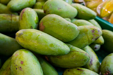 Vibrant Green Mangoes Heap, Close-Up Market Display
