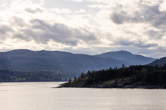 Tranquil Landscape of Gulf Islands and Hills Under Cloudy Sky - Powered by Adobe
