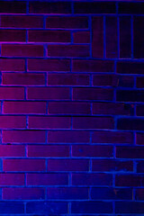 Vibrant neon purple and blue lights create a striking visual effect on a textured brick wall, perfect for backgrounds and design projects