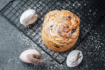 Delicious pastry topped with powdered sugar and surrounded by Easter eggs