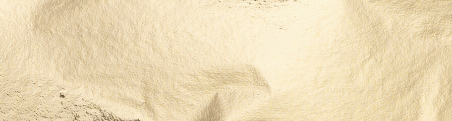 Gold foil texture with a soft, pale background. Smooth, shiny surface with subtle shimmer and refined elegance. Minimal, clean design with a warm yellow gradient. Premium, decorative material with a.