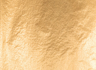 Gold metallic foil background with a soft, smooth texture. Elegant design in warm yellow tones, featuring a shimmering glow and refined matte finish. Luxury, abstract pattern with bright, illuminated.