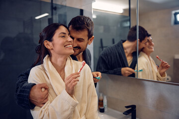 Loving couple enjoying in their morning routine in bathroom.