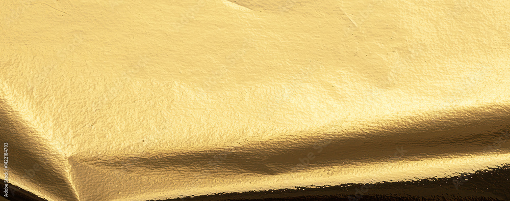 Poster gold metallic foil texture with a folded, smooth surface. shiny, reflective material in warm yellow 