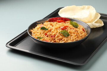 South Indian food Tomato Rice served in a ceramic bowl 