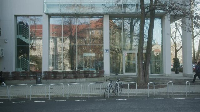 A clear 4K video capturing the facade of the Faculty of Mechanical Engineering at Politechnika Wrocławska in Wrocław, Poland. Shot during a sunny day