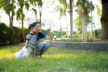 While in vacation at home, a mother engages in activities with little kid in the park