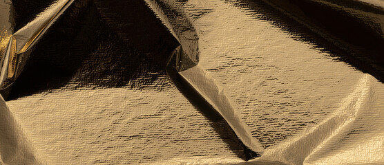 Golden foil with reflective, shiny folds creates a sleek, opulent design. Gilded, metallic texture...