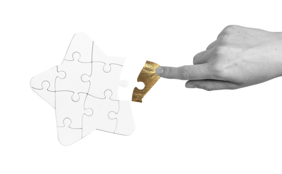 Golden star-shaped puzzle piece held by a hand, symbolizing success, recognition, and the fulfillment of goals. This piece represents unique contribution, teamwork, and the pursuit of aspiration,.
