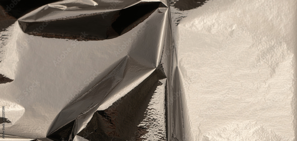Aufkleber silver foil with shiny, metallic texture creates a smooth, reflective surface. crinkled and folded a