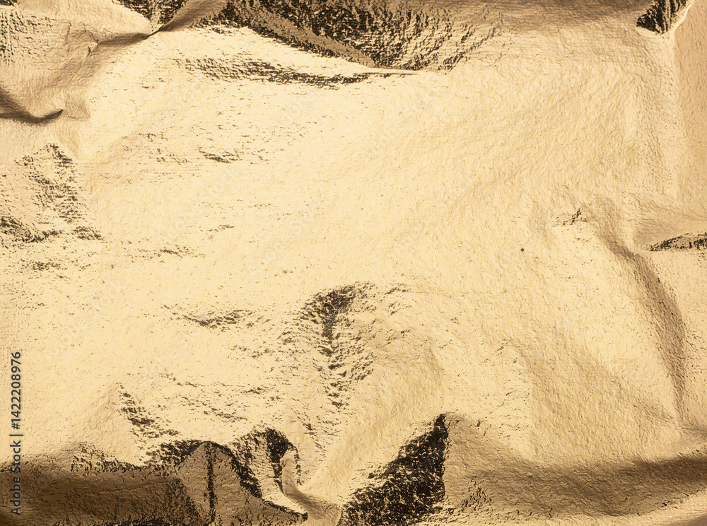 Poster smooth yet subtly crinkled sheet of shiny gold foil paper with reflective metallic texture, glowing 