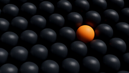 A single orange ball stands out among a group of black balls, symbolizing uniqueness, individuality, or bold difference. 3D Render.