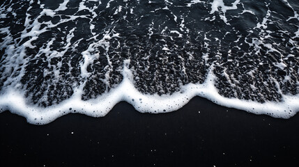 black volcanic sand receding waves patterns
