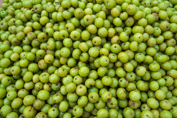 Fresh Ceylon gooseberries (amla) at a local market, native to Sri Lanka, sour antioxidant-rich fruit used in jam and jelly.  Food and travel.